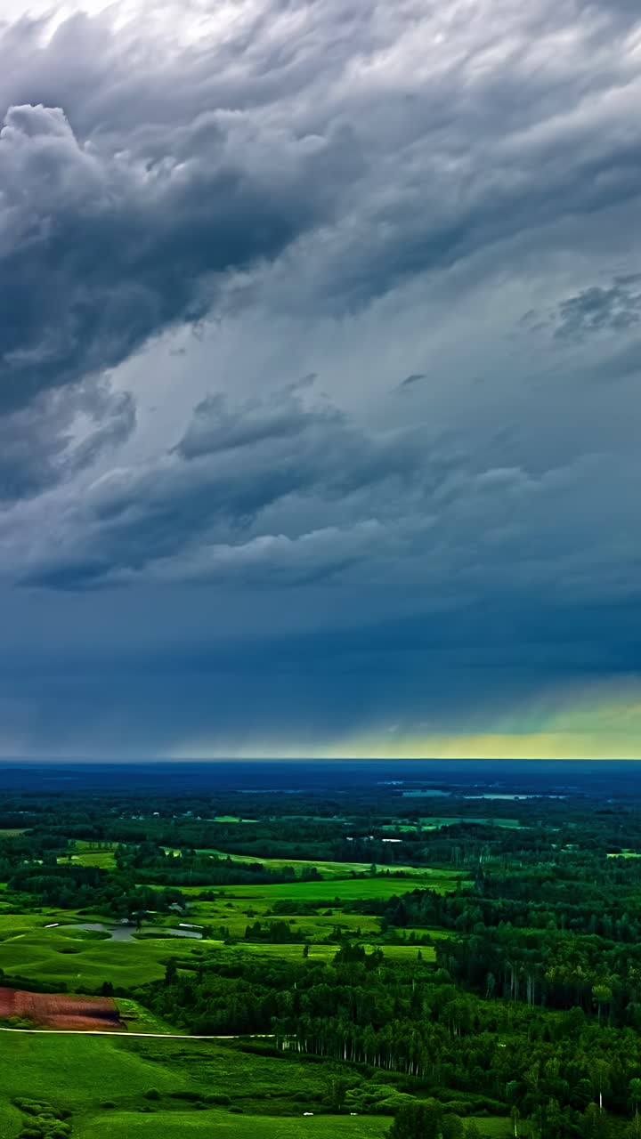 Dramatic clouds over green fields in a time-lapse capturing nature's mood