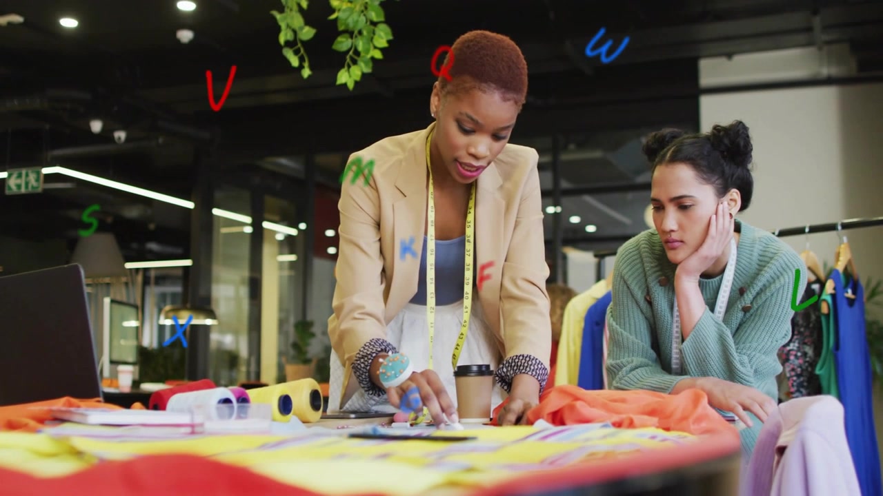 Standing designer leaning over fashion table aligning fabric marking pattern eliciting client nod