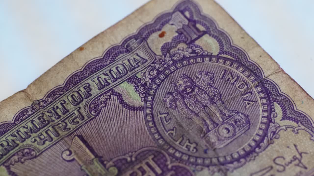 Close-Up of Vintage Indian 1 Rupee Note with indian National Emblem and finance ministry Manmohan Singh signature. internal shot, tilt up shot, 4k.