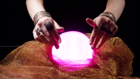 close up fortune teller hands using crystal ball