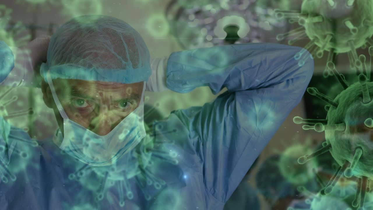 Animation of covid 19 cells over caucasian male surgeon wearing face masks in operating theatre