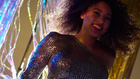 close up of woman in nightclub bar or disco dancing with sparkling lights 16