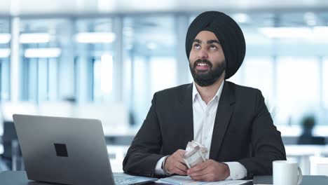 happy sikh indian businessman counting money