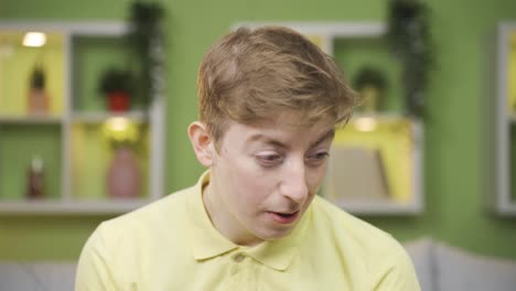 close-up of shy young man looking at camera.