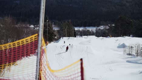 Beautiful-view-of-a-skiing-slope,-people-skiing-in-slow-motion