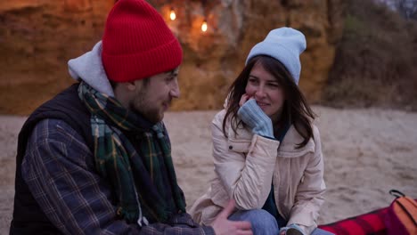 Couple Enjoying a Cozy Evening by the Beach