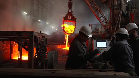 workers and molten metal in a steel foundry