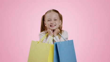 happy little girl with shopping bags