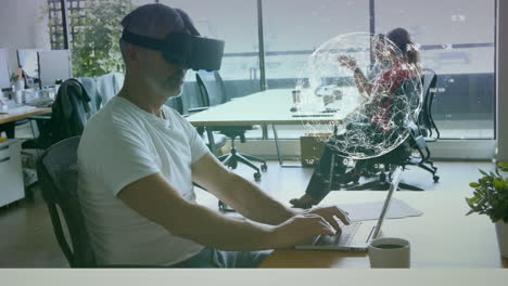 man working on laptop with a virtual reality glasses