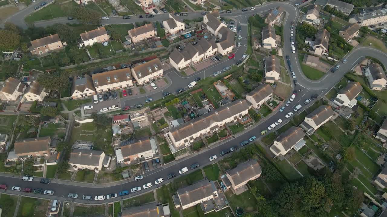 Drone flying over houses on the island of Portland, in Dorset, UK, during the sunset.