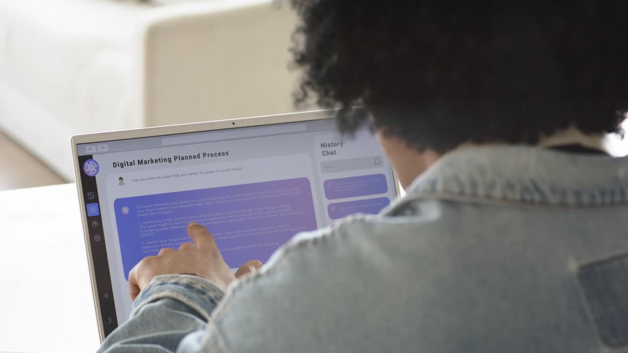 Upon blank panel appearing, individual typing and scrolling marketing plan on laptop in living room