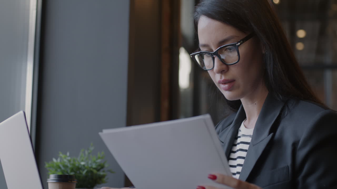 Woman reviewing documents in a cafe