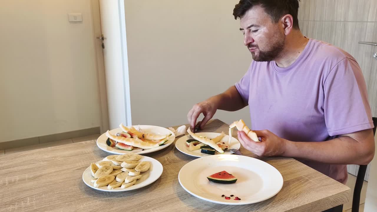 Man Eating Fruit at Table