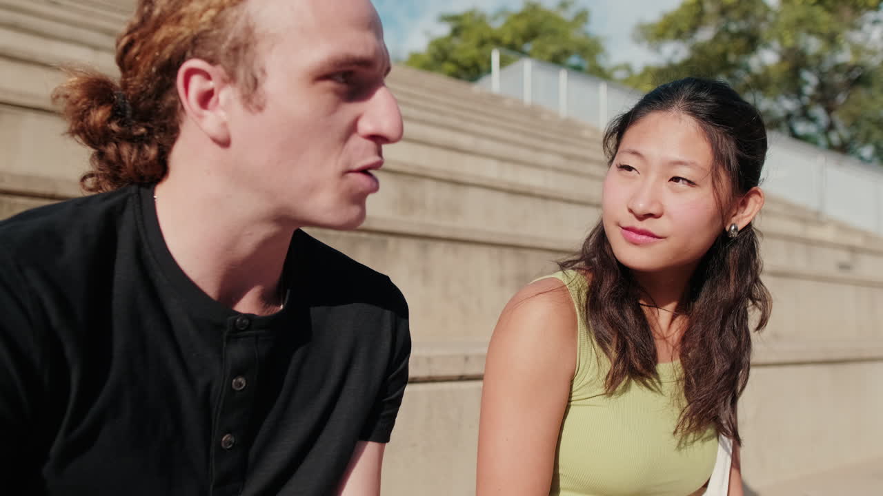 European guy talking to the girl, a conversation between friends or students