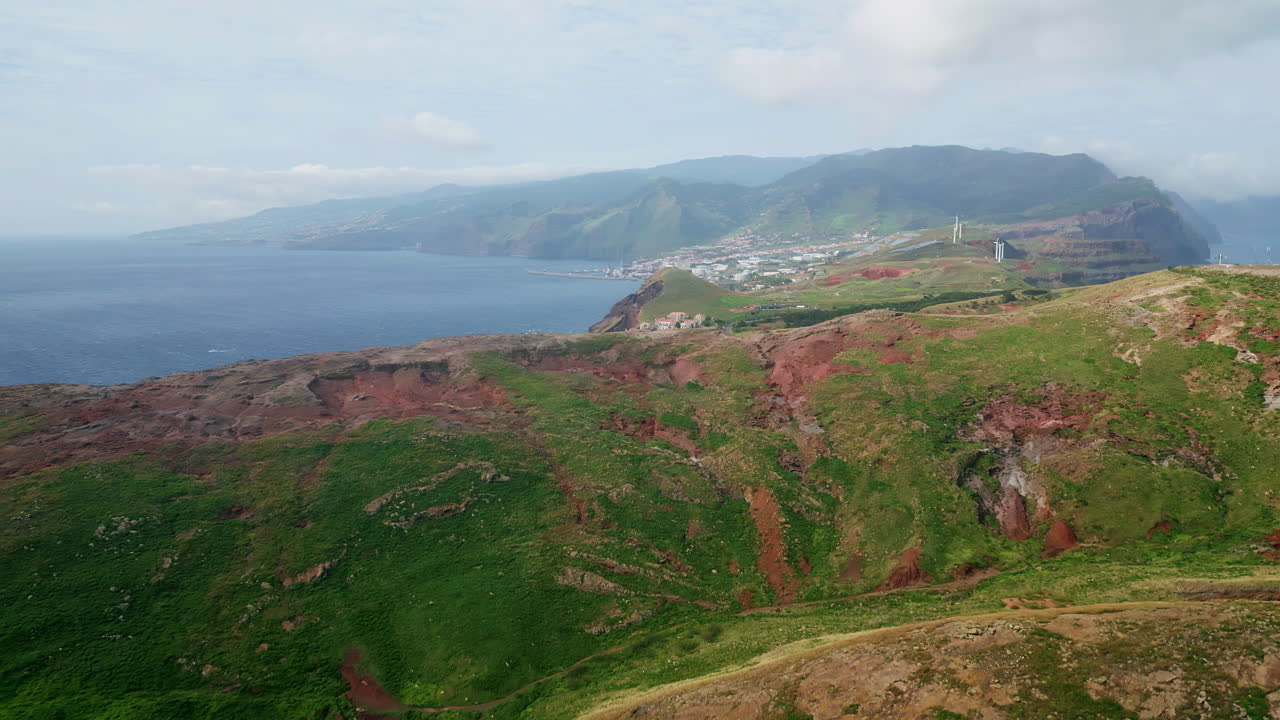 Panorama remote tropical island aerial view. Coastal town buildings at shore