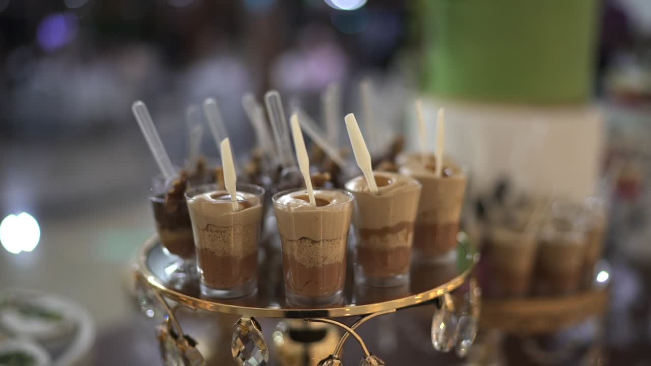 Closeup at chocolate pudding wedding deserts decorated in party table