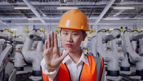 factory worker stopping a robot