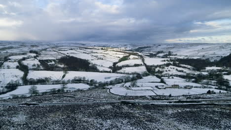 North-York-Moors-Snow-Scene-Drone-Flight,-Rosedale,-Flight-over-Castleton-Westerdale,-Winter-cold-and-moody-clouds,-Phantom-4,-Clip-5