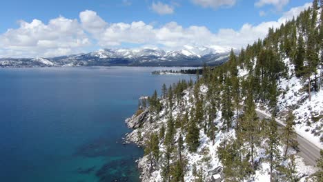 lake tahoe winter aerial view: snow covered mountains and crystal clear water