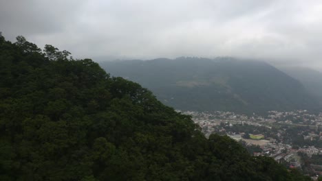 Aerial-reveal-of-Panajachel,-Guatemala,-early-morning