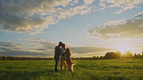 couple and dog at sunset