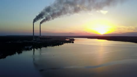 landscape of an industrial estate with pipe factory smoke near river
