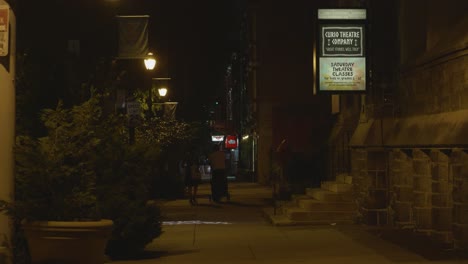 Baltimore-Avenue-sidewalk,-night,-outside-Cavalry-Church-and-curio-theater