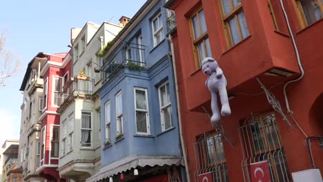 colorful buildings with a hanging teddy bear