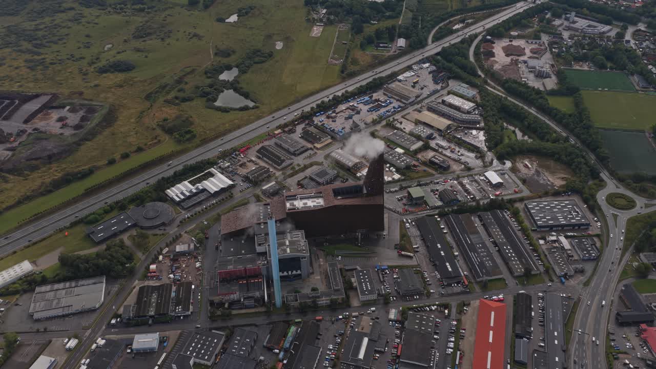 Steam plume above utility plant; energy production captured by drone
