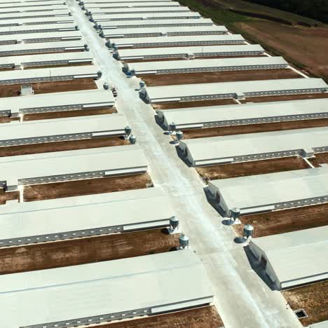white buildings of manufacturing on the field. view from above on a new industrial complex. flight over warehouses. aerial view.