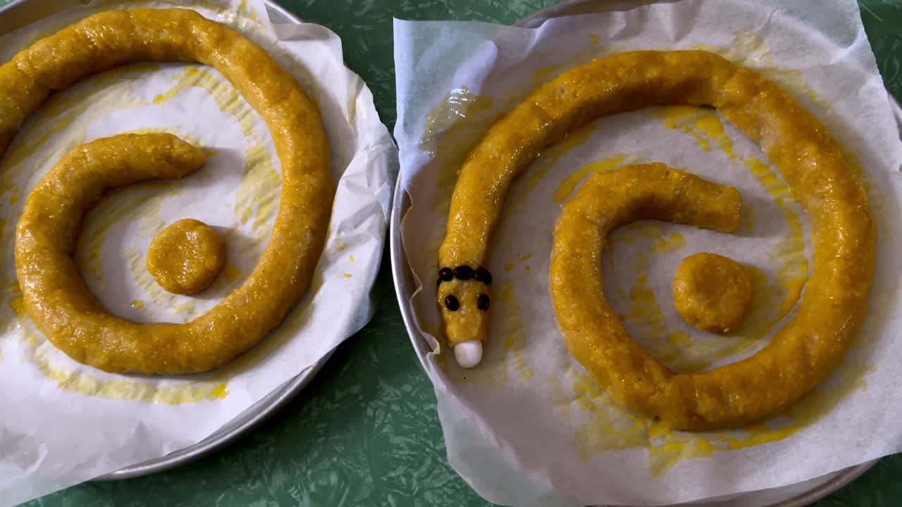 Two traditional Italian cakes, Torciglione or tortiglione shaped like snakes, ready for baking. For cooking, holiday, or cultural content