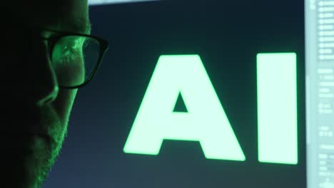 a man with glasses standing in front of an ai display, with the word ‘ai’ shown prominently on the screen. green light dark