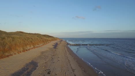 aerial: the beach between vlissingen and dishoek during sunset