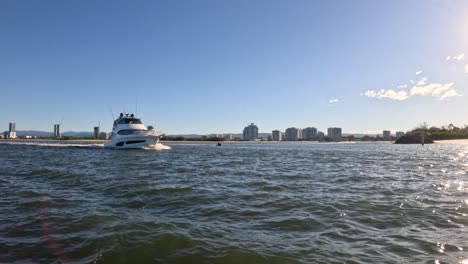 a yacht cruising near gold coast skyline