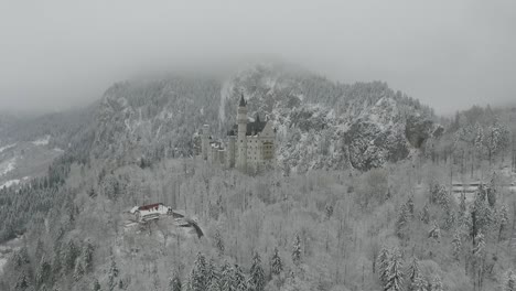 aerial view of neuschwanstein getting altitude while flying towards to the castle