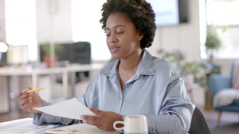 happy african american casual businesswoman making video call in office, slow motion