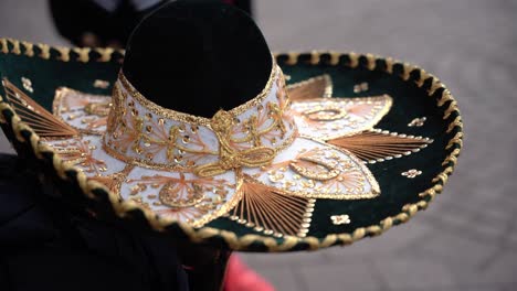 close up of a guy wearing on a traditional mexican sombrero