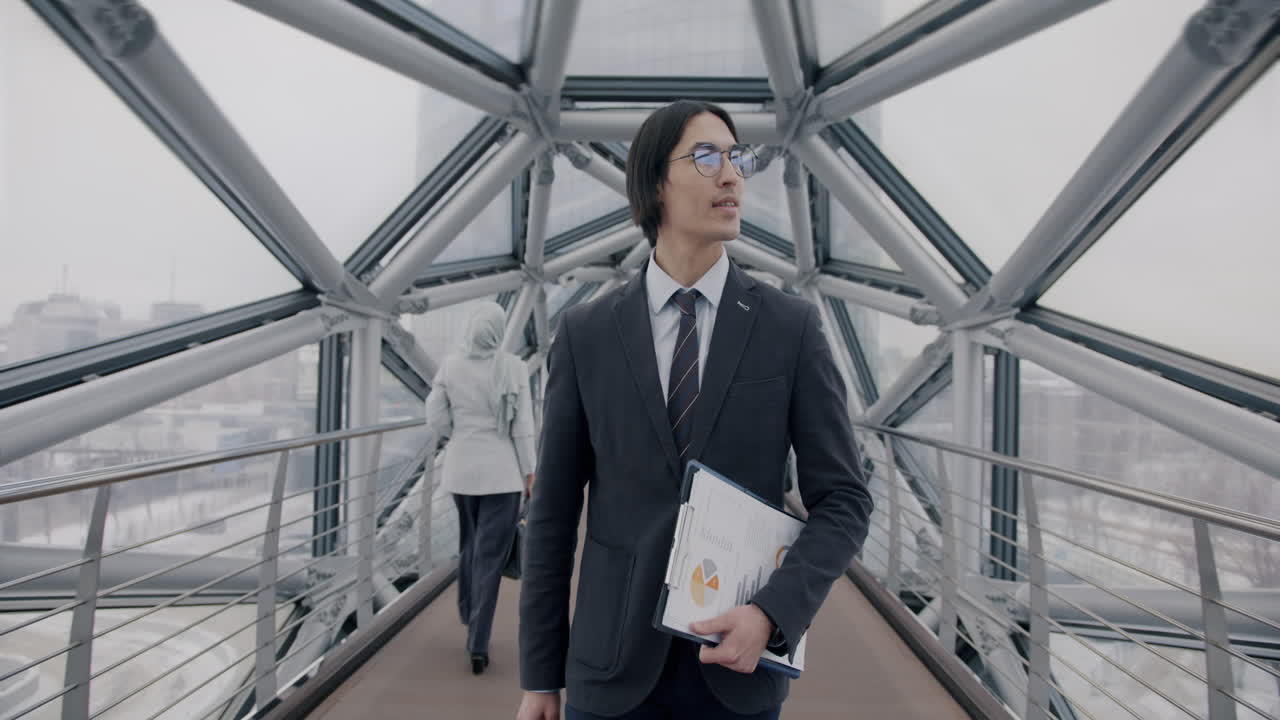 Businessman Walking on a Modern City Bridge