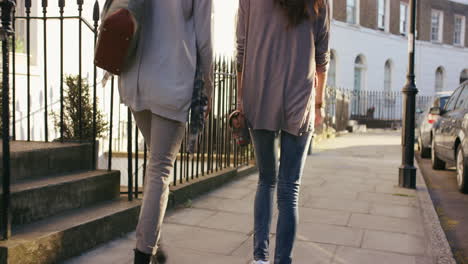 two women walking down a city street