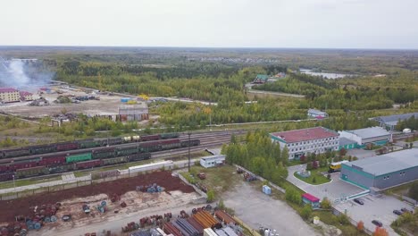 industrial complex with train tracks and storage yards