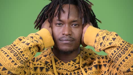 young handsome african man covering ears as three wise monkeys concept