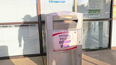 American-Man-Drops-Mail-in-Ballot-Letter-in-Slot-at-Voting-Booth-with-Offical-Ballot-Drop-Box-Sign-for-Democratic-Government-Election-in-Presidential-Race