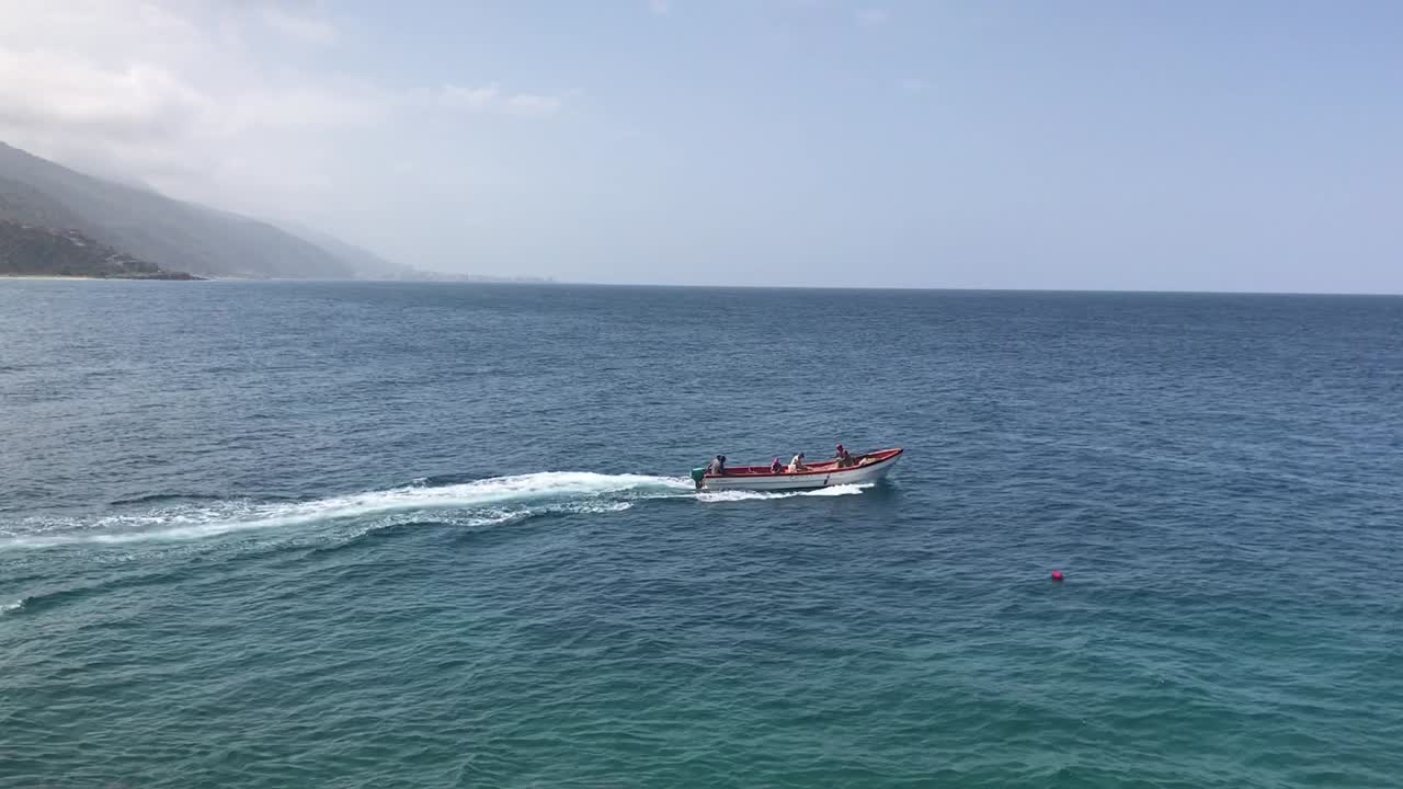 Just a random boat sailing around the port in La Guaira