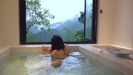 woman relaxing in bathtub in spa resort