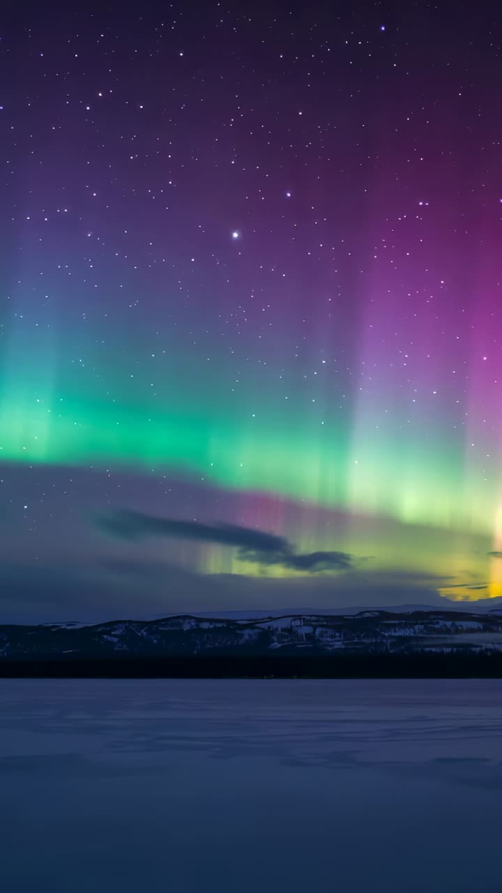 Vertical video: Shifting aurora rising into purple pillar after solar pulse over ice lake, stars