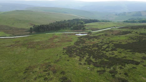 A-tranquil-picture-of-hills-and-a-piece-of-forest-covered-in-a-mist