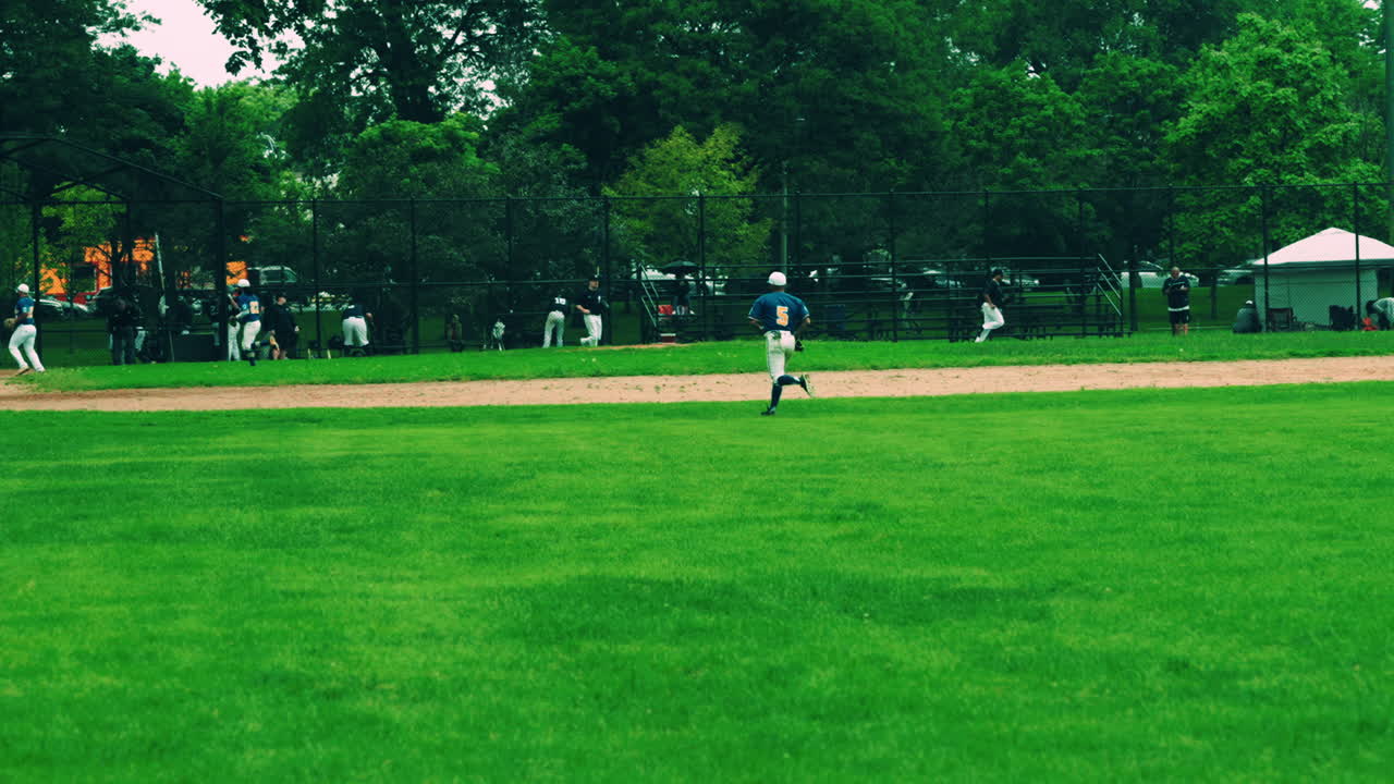 A baseball game or practice in progress on a green field.