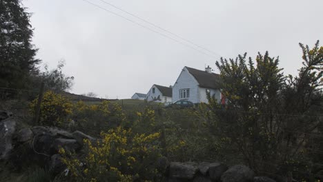 push in shot of thatch roof cottages in the highlands of ireland
