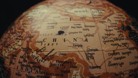close-up view of a vintage world globe focusing on the asian continent