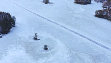 aerial drone shot of straight ice road on an icy lake